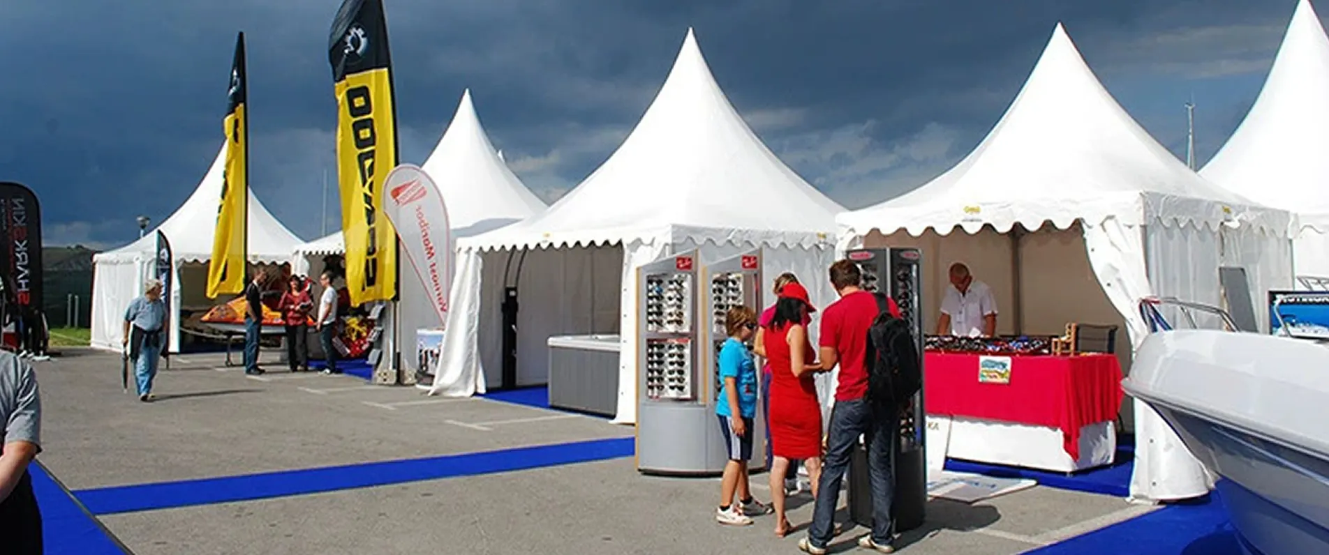 trade show tent with side walls and branded canopy at an outdoor expo